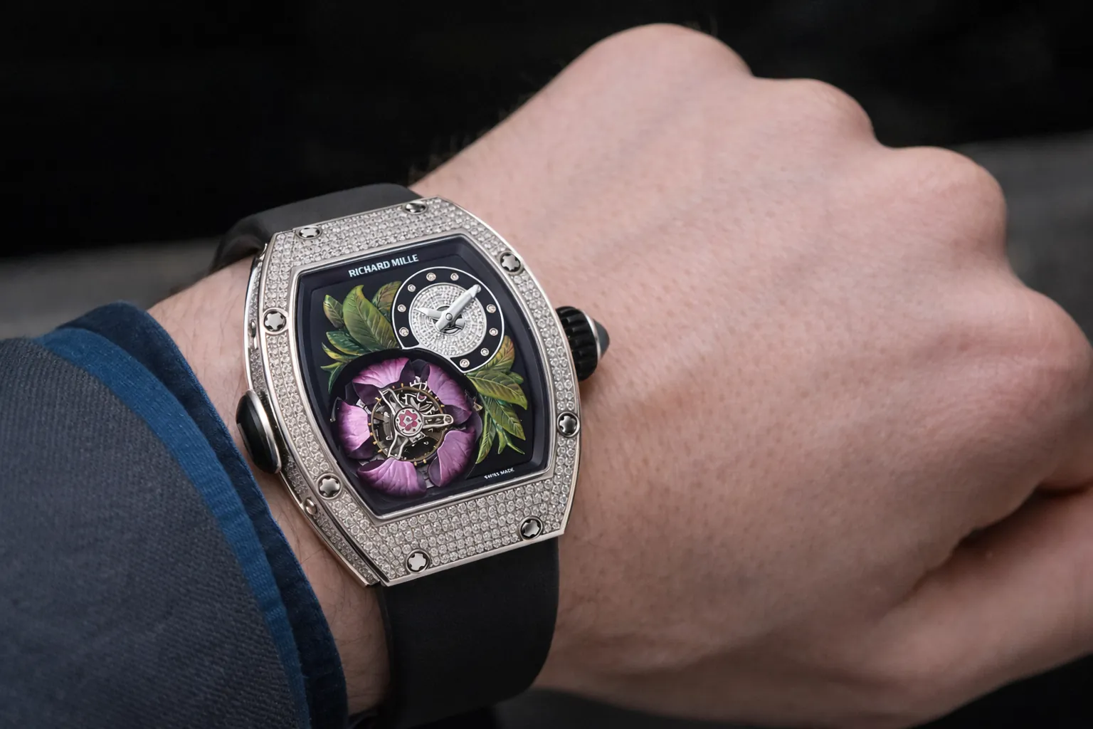 Stunning on-wrist shot of the Richard Mille RM 19-02 replica. This exceptional timepiece features a brilliant diamond-encrusted white gold tonneau case, showcasing an intricate hand-painted floral dial with a visible tourbillon movement. Combining artistic craftsmanship with ultra-luxury design, this premium super clone is a true statement piece for sophisticated collectors.