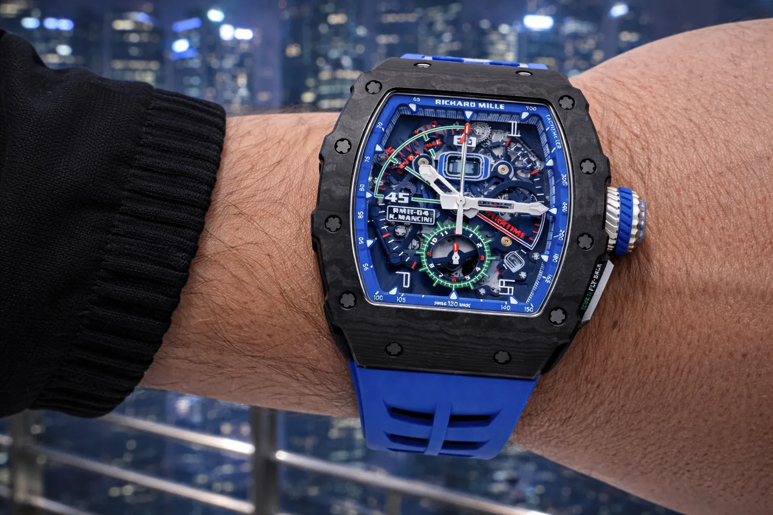 Stunning on-wrist shot of the Richard Mille RM 11-04 replica, the iconic K.Mancini racing chronograph timepiece. Featuring a lightweight black carbon TPT tonneau case, a vibrant blue skeleton dial with full chronograph functions, and a sporty blue rubber strap. This premium super clone delivers the legendary RM race-inspired design and high-performance horology for collectors.