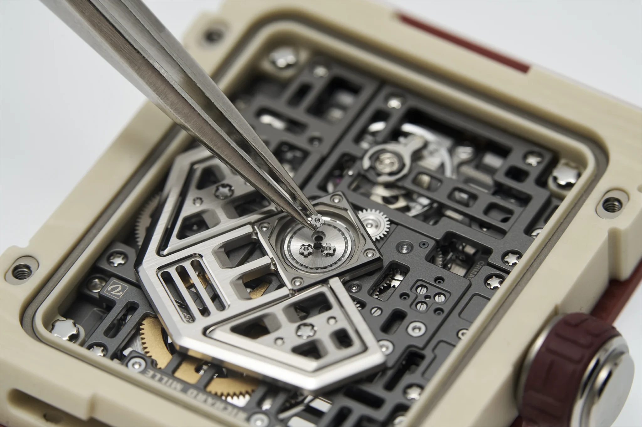 Close-up of UMI Factory RM 16-02 skeleton movement with visible gears and automatic rotor being adjusted - Custom RM005-S calibre