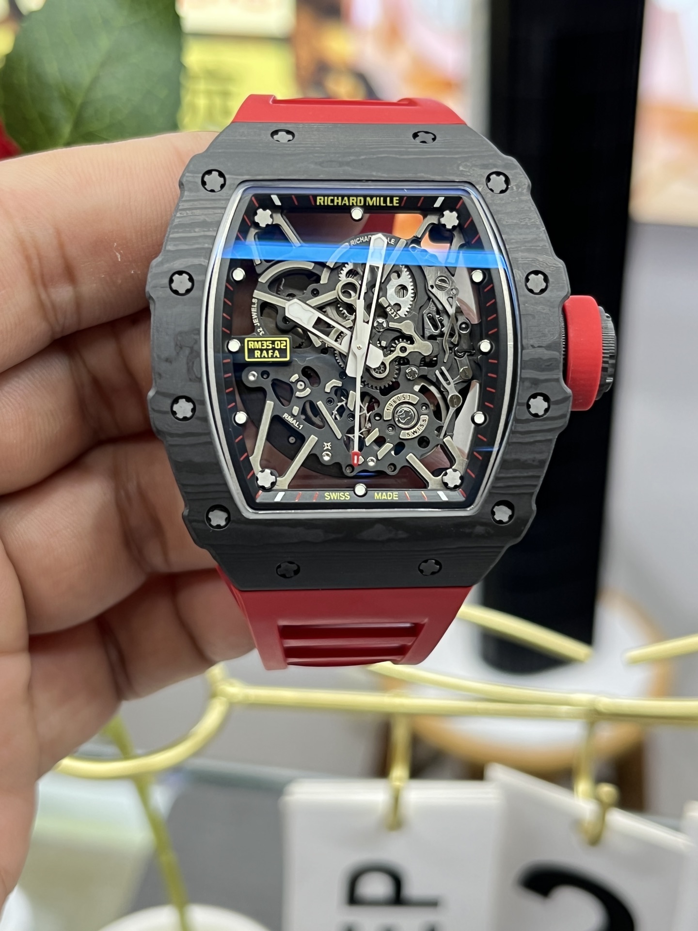 Richard Mille RM35-02 Rafa Skeleton Watch Carbon Fiber Case Red Rubber Strap Centered Front View In Hand Close-Up