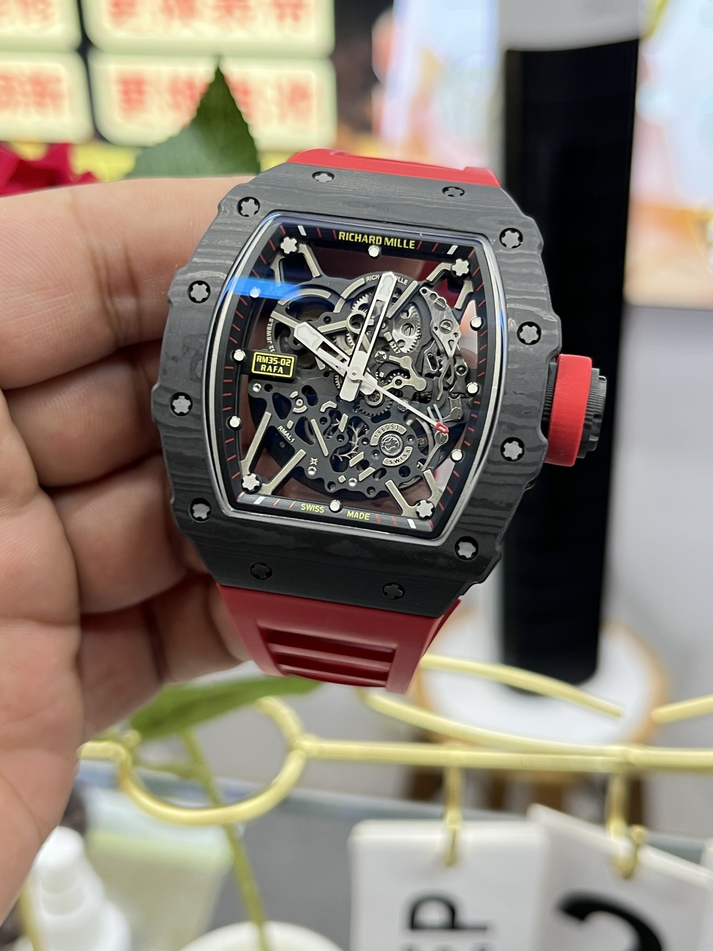 Richard Mille RM35-02 Rafa Skeleton Watch Carbon Fiber Case Red Rubber Strap Dial In-Hand Front Angle Lifestyle Detail