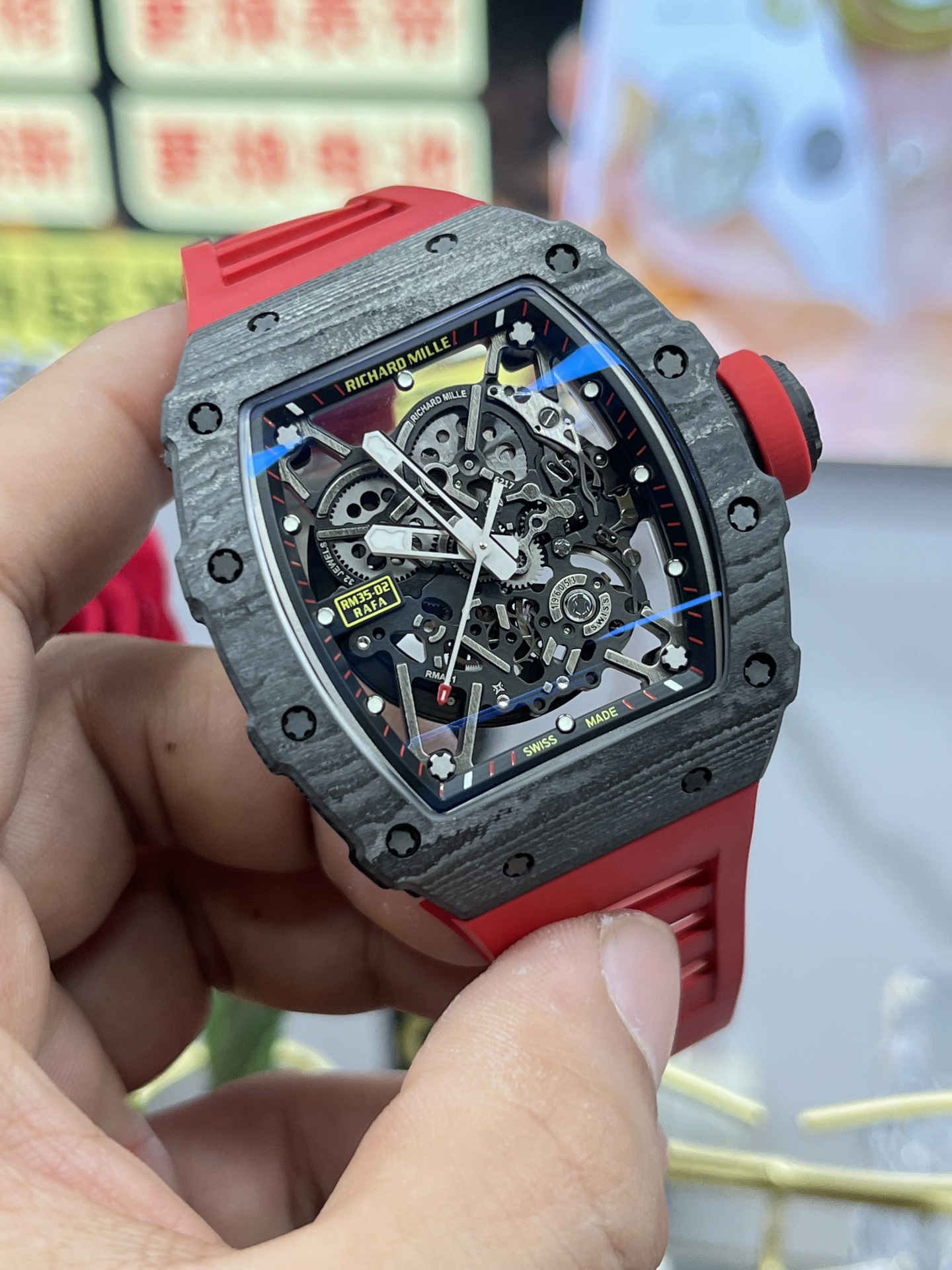 Richard Mille RM35-02 Rafa carbon fiber case black skeleton dial red rubber strap angled front view handheld display