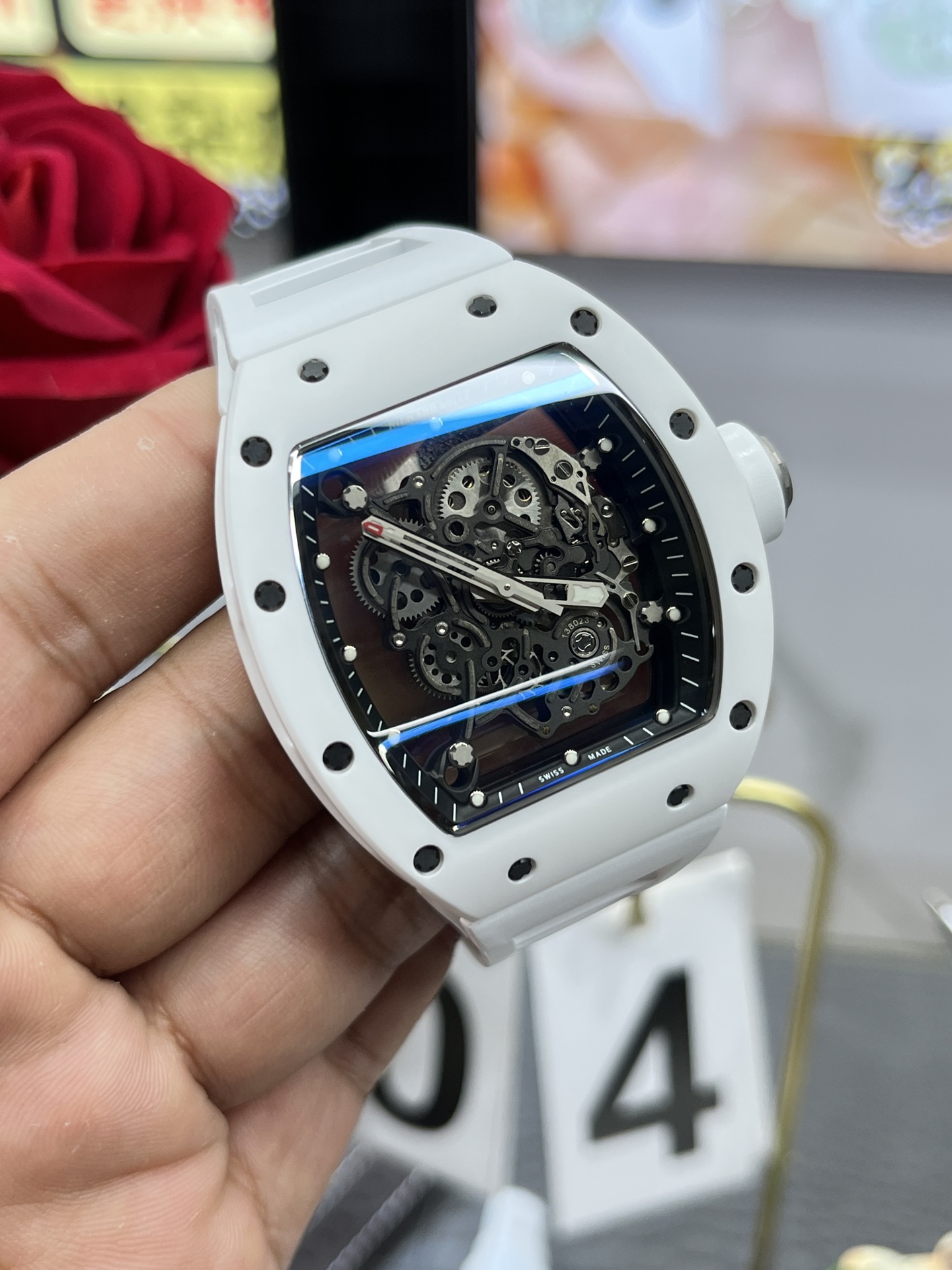 Richard Mille RM055 BBR white ceramic case black skeleton dial white strap skeleton movement handheld angled detail view