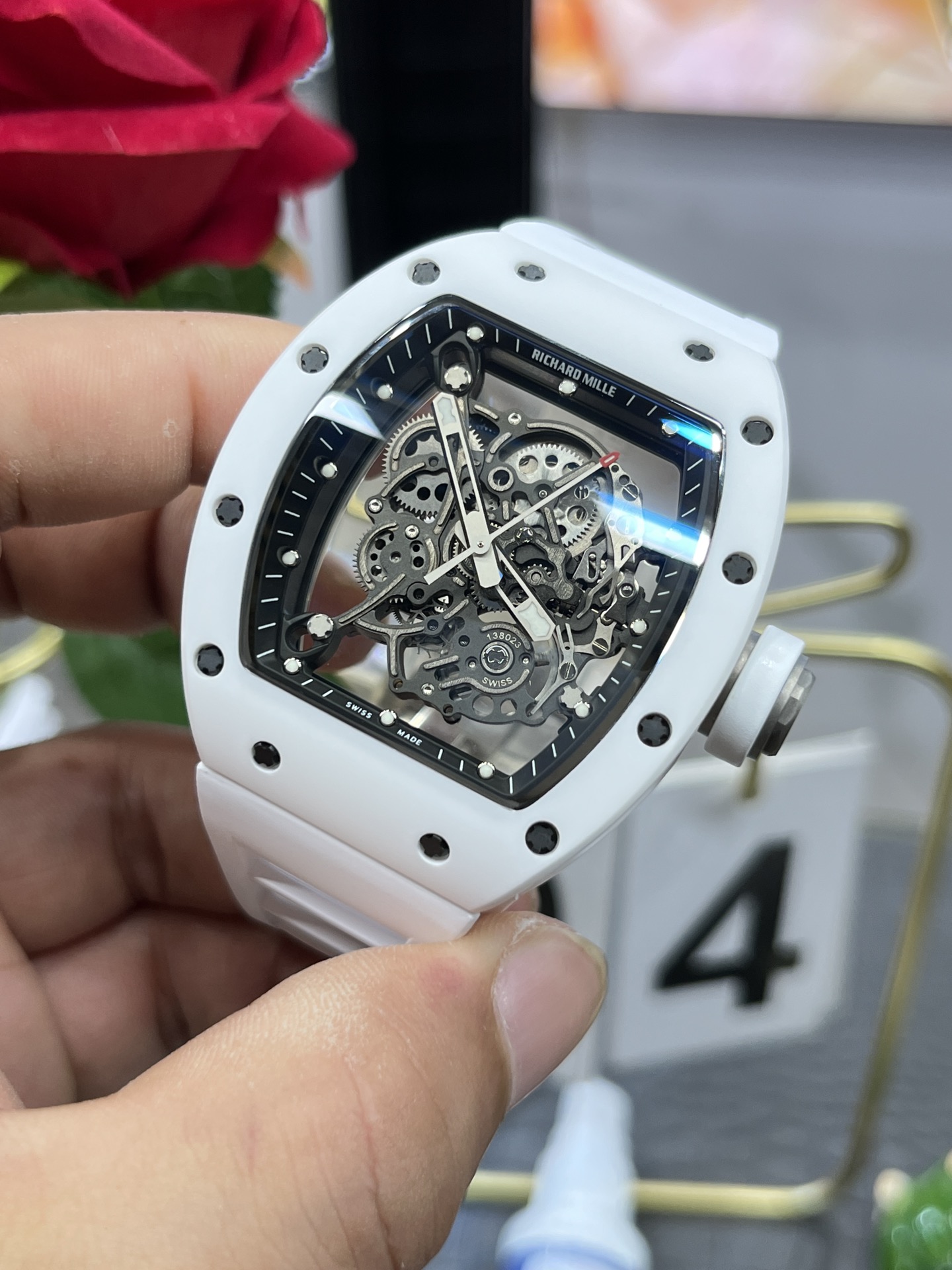 Richard Mille RM055 BBR white ceramic case black skeleton dial white strap skeleton movement handheld side detail view