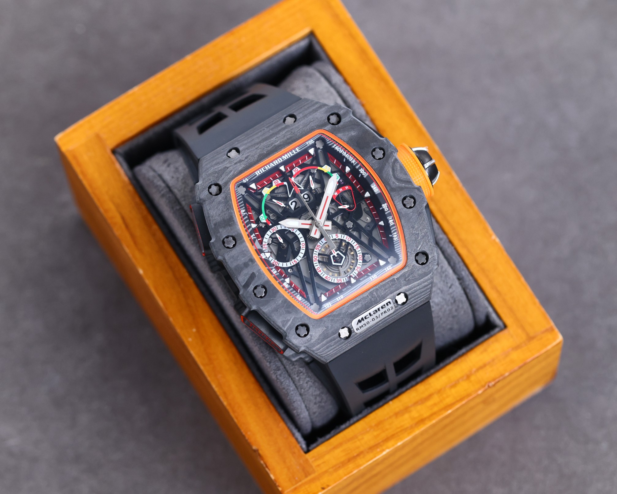 Richard Mille RM50-03 McLaren F1 Tourbillon Carbon Case Black Orange Accents Black Rubber Strap Watch Box Angle View