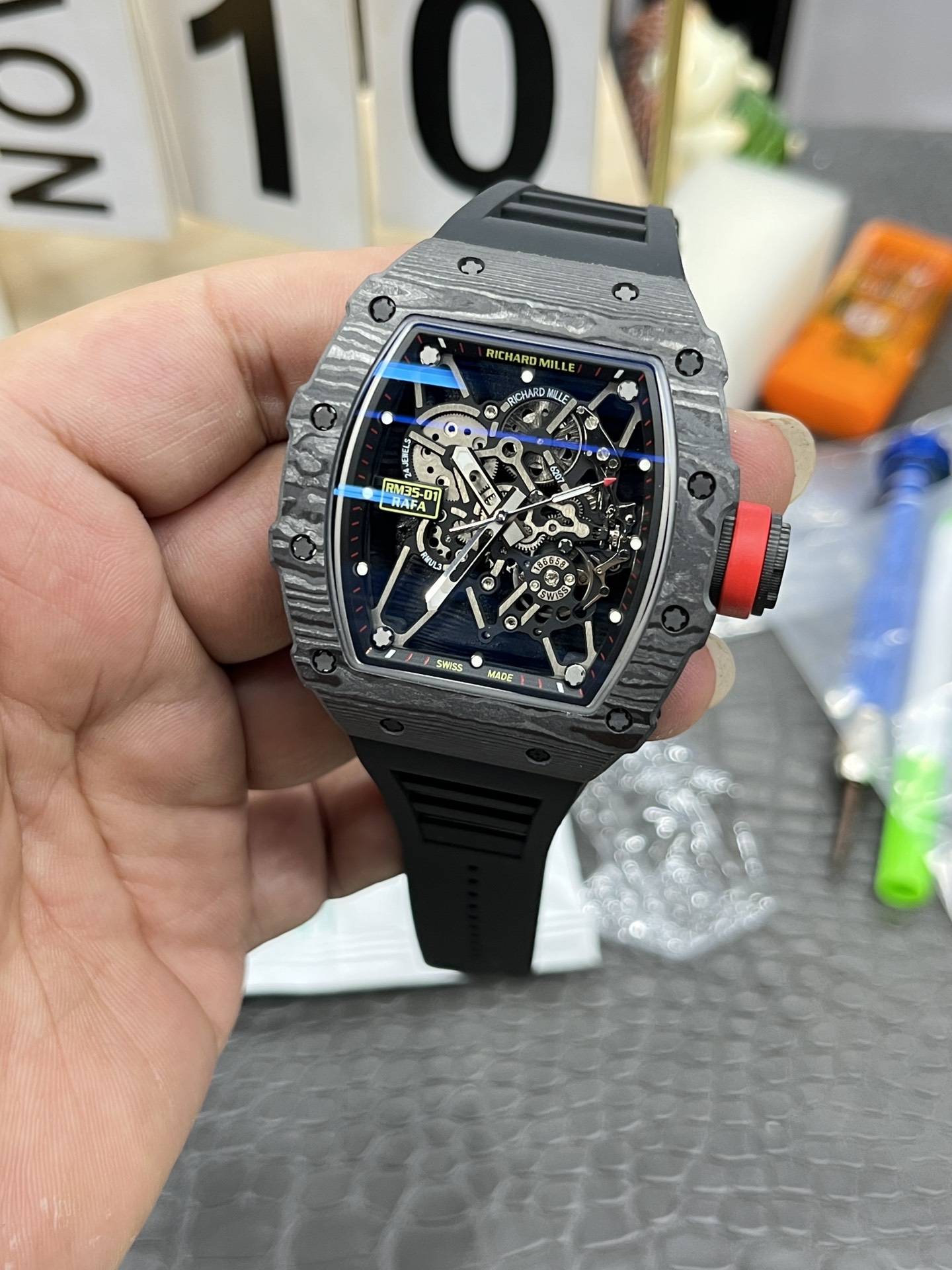 Richard Mille RM35-01 Rafa carbon fiber case black dial red crown black strap skeleton movement handheld front view