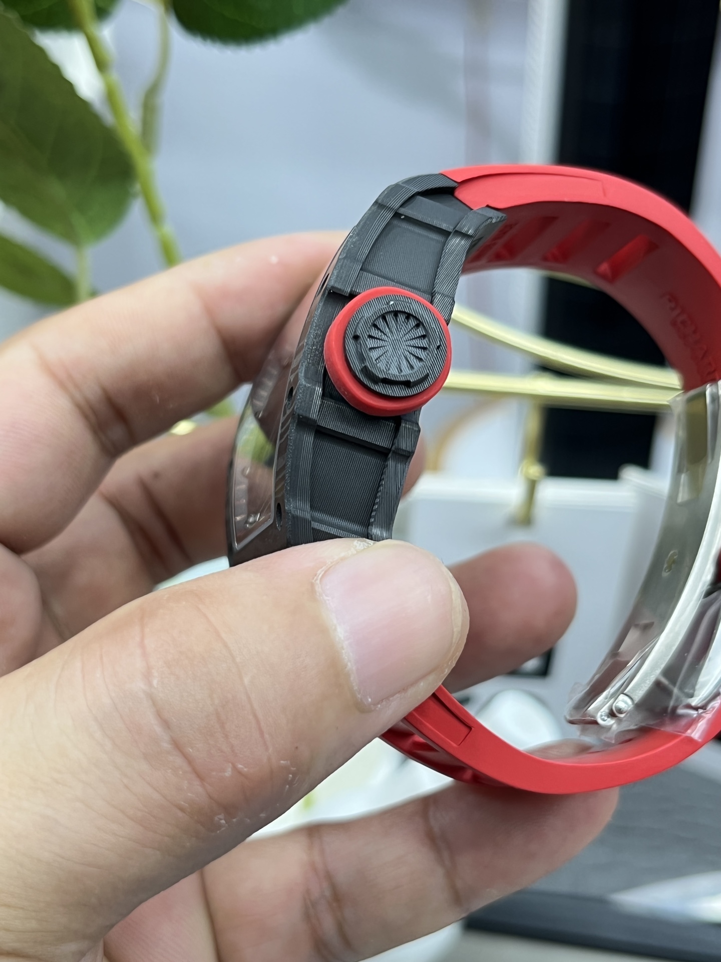 Richard Mille RM35-02 Rafa Skeleton Watch Carbon Fiber Case Red Rubber Strap Crown Detail Side In-Hand Texture Close-Up