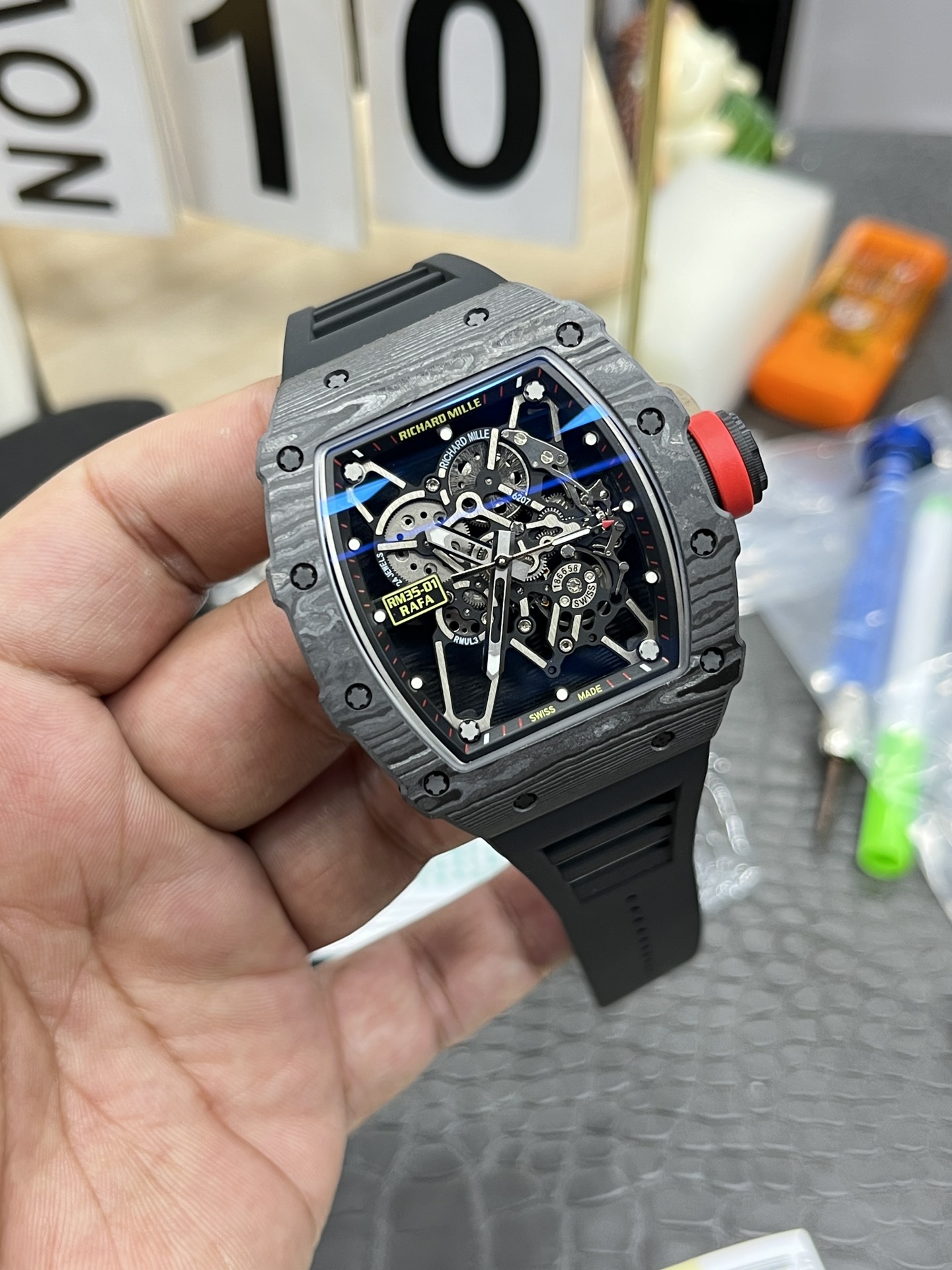Richard Mille RM35-01 Rafa carbon fiber case black skeleton dial red crown black strap handheld angled detail view