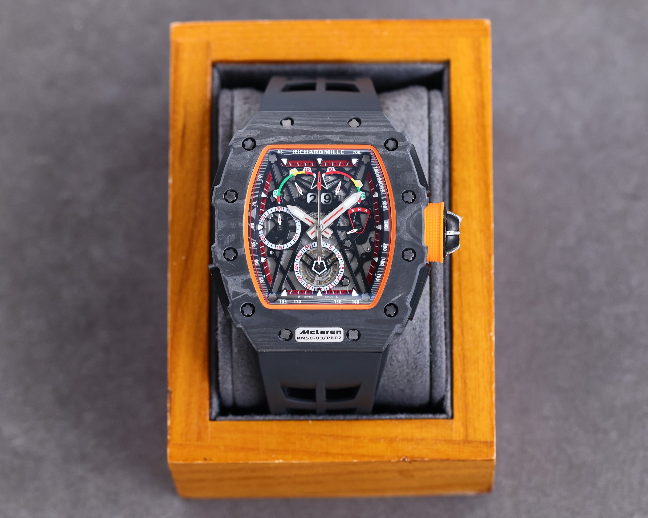 Richard Mille RM50-03 McLaren F1 Tourbillon Carbon Case Black Orange Accents Black Rubber Strap Watch Box Display Front View