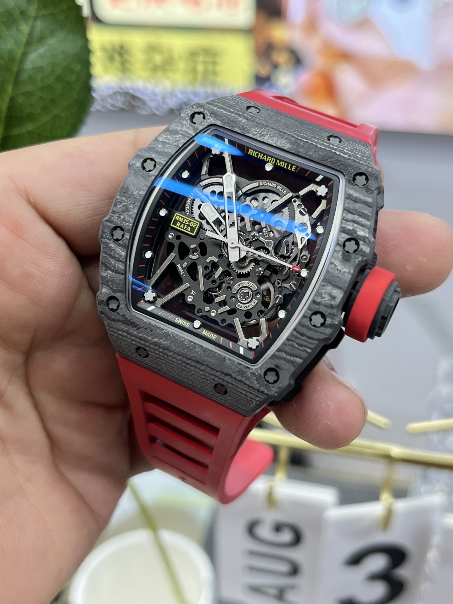 Richard Mille RM35-02 Rafa carbon fiber case black skeleton dial red rubber strap side angle view handheld detail display