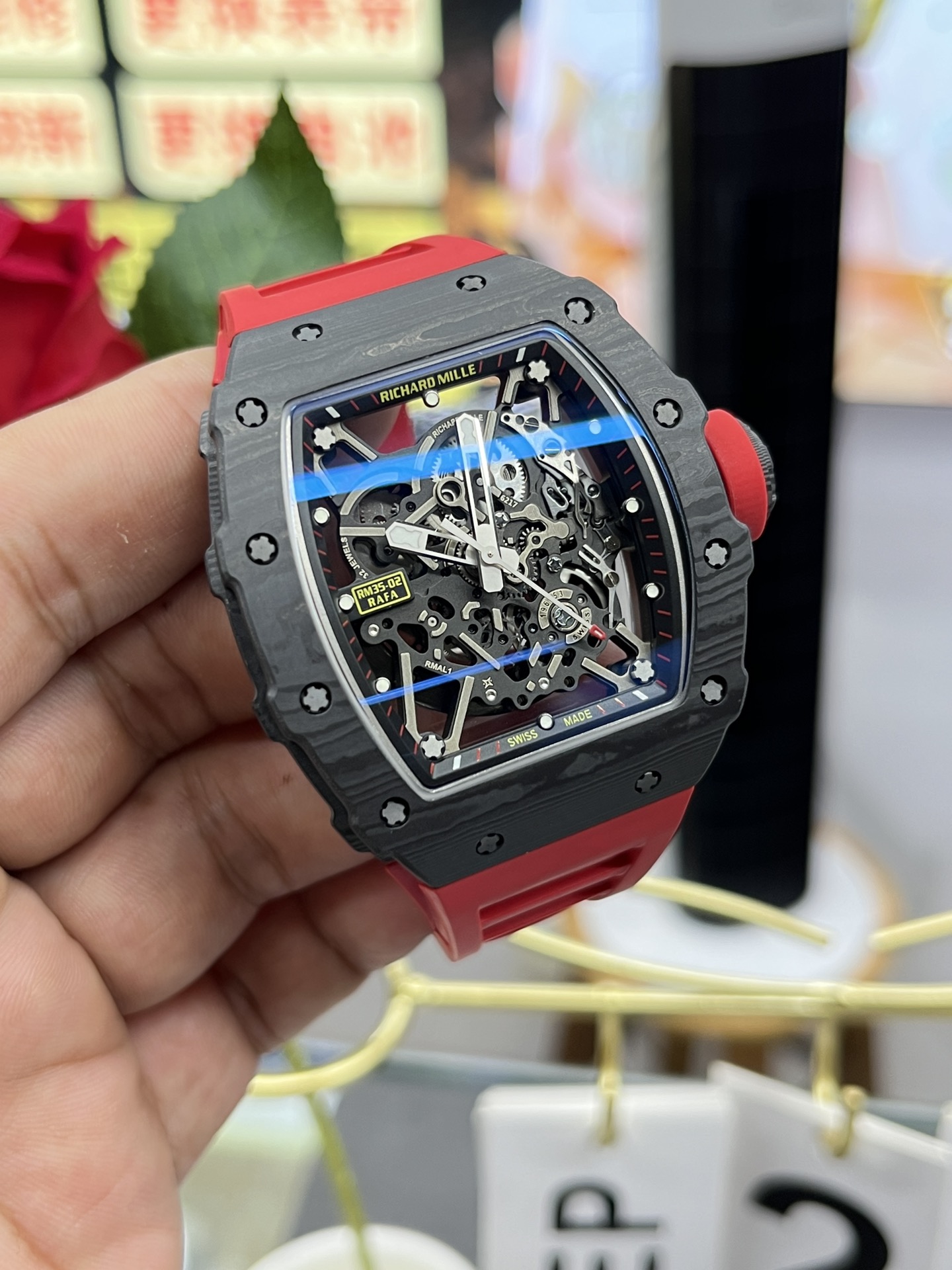Richard Mille RM35-02 Rafa Skeleton Watch Carbon Fiber Case Red Rubber Strap Angled Front Perspective In Hand Close-Up