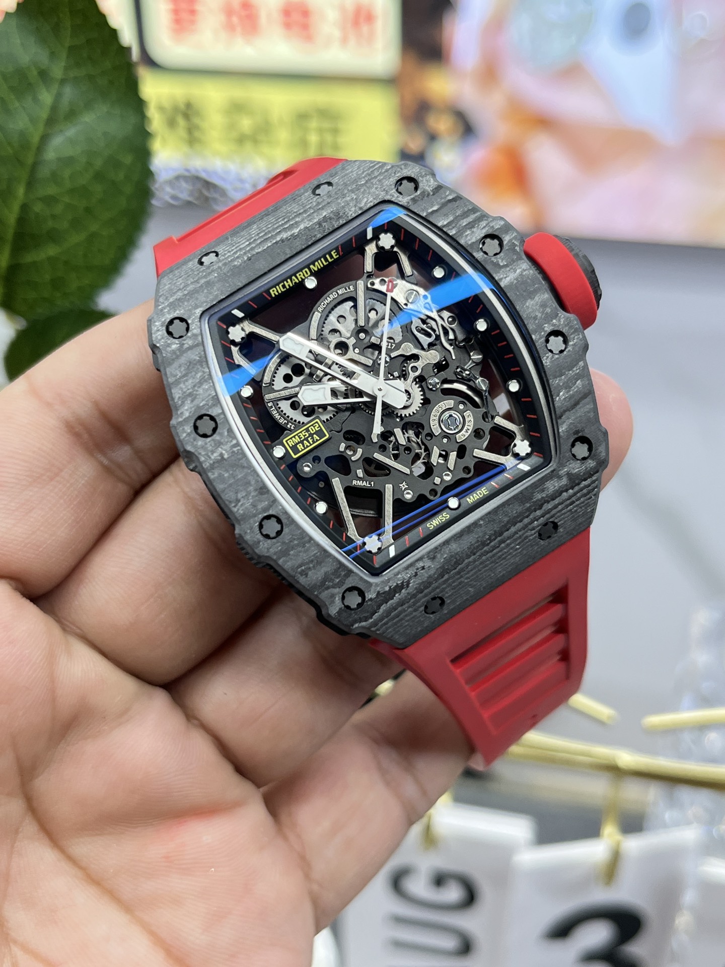 Richard Mille RM35-02 Rafa carbon fiber case black skeleton dial red rubber strap angled side view handheld display