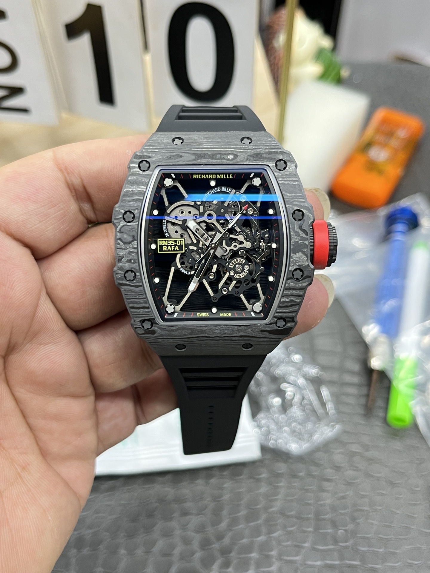 Richard Mille RM35-01 Rafa carbon fiber case black skeleton dial red crown black rubber strap front view handheld display